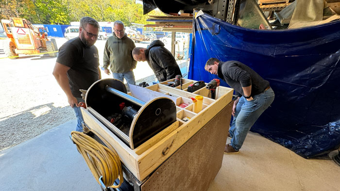 <b>Carl A. Nelson & Company General Superintendent Mike Harris, left, Southeastern Community College construction trades instructor Doug Riley, and CANCO project engineers TJ Duncan and Will Porter, take a close look at the shop cart completed by the team from Mediapolis High School. Mediapolis took first place in the 2024 High School Skills Challenge, the eighth hosted by the Burlington, Iowa-based construction firm. </b>(CANCO)