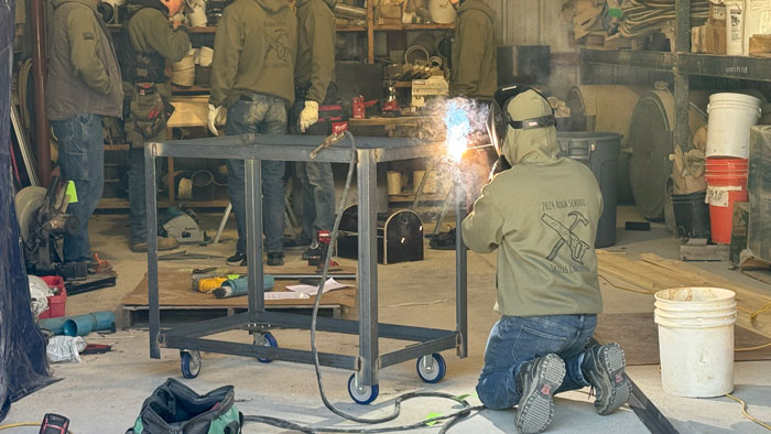 <b>A member of the team from Mediapolis High School welds the frame of a shop cart the students built for the 2024 High Schoo Skills Challenge hosted and organized by Carl A. Nelson & Company at its warehouse and yard in Burlington, Iowa. </b>(CANCO)