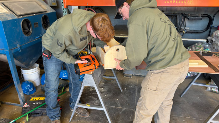 <b>Members of the team from Burlington High School nail together the tool cady that was a feature of the shop cart they and students from six other southeast Iowa high schools built during the 2024 High School Skills Challenge at Carl A. Nelson & Company in Burlington, Iowa.</b> (CANCO)