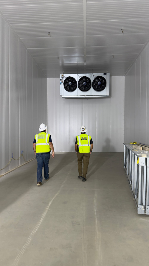 Superintendent, Project Manager tour construction site in food-grade production facility.