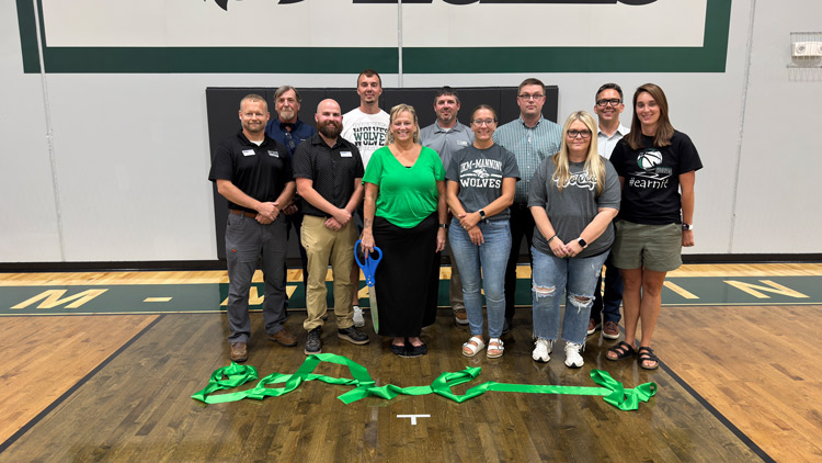 Carl A. Nelson & Company team members join district leaders and design team members for a ribbon-cutting at IKM-Manning Community School District.