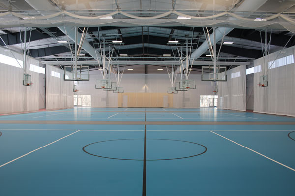 Multi-court, multi-sport courts inside community recreation center.