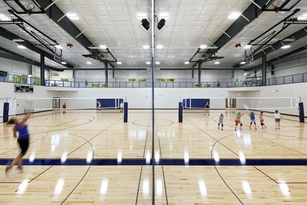 Gym floor and elevated walking track being used at city-owned community center building.